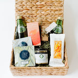 The Light Afternoon Treats basket includes two Perrier bottles, California gummy bears, handcrafted chocolate truffles, Steep Echo tea, Santa Barbara Company tapenade, and Rustic Bakery gluten-free sourdough flatbread crackers—ideal for snacking.