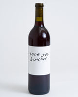 A bottle of Love You Bunches Natural Sangiovese featuring a simple white label with the handwritten message "Love You Bunches" in black ink, displayed against a plain white background.