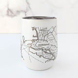 The Map of the San Francisco Bay Area Insulated Wine Tumbler features a white engraved stainless steel design with a silver outline map of Oakland, Berkeley, Piedmont, and Alameda—an ideal SF Bay Area gift shown on a white marble background.