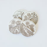 Old Santa Barbara Mission Letterpress Coasters: a set of four round cotton coasters featuring brown vintage-style printing and text, with scenes like the Santa Barbara Mission in a layered, overlapping pattern on white.