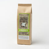 A brown paper bag of Petite Sea Salt & Olive Oil Santa Barbara Popcorn, featuring a green label with popcorn imagery and product details. California grown and gluten free.