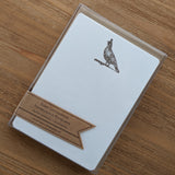 Quail Letterpress Note Cards - Set of 8, featuring quail art, displayed on a wooden surface.