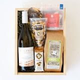 The Stolpman Wine & Snacks Gift Box features a bottle of Stolpman Vineyards Sauvignon Blanc, California artisan snacks, gourmet popcorn, caramels, crackers, pistachios, and spiced apple tea—all beautifully arranged in a gift box.