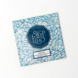 A Tend Single Tea Sachet with a blue and white wave pattern. The label reads Steep Echo, Herbal Tea, Caffeine Free, All Natural Organic Olive Leaf Teas, Santa Barbara, California.