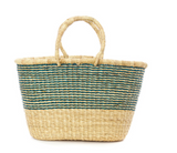 The Z - Turquoise Farmers Market & Beach Tote is a handmade straw tote bag with two handles. The bottom is natural straw, while the top has horizontal turquoise and natural stripes, inspired by traditional Ghana basket designs. White background.