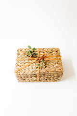 Water hyacinth basket with ribbon & eucalyptus leaves